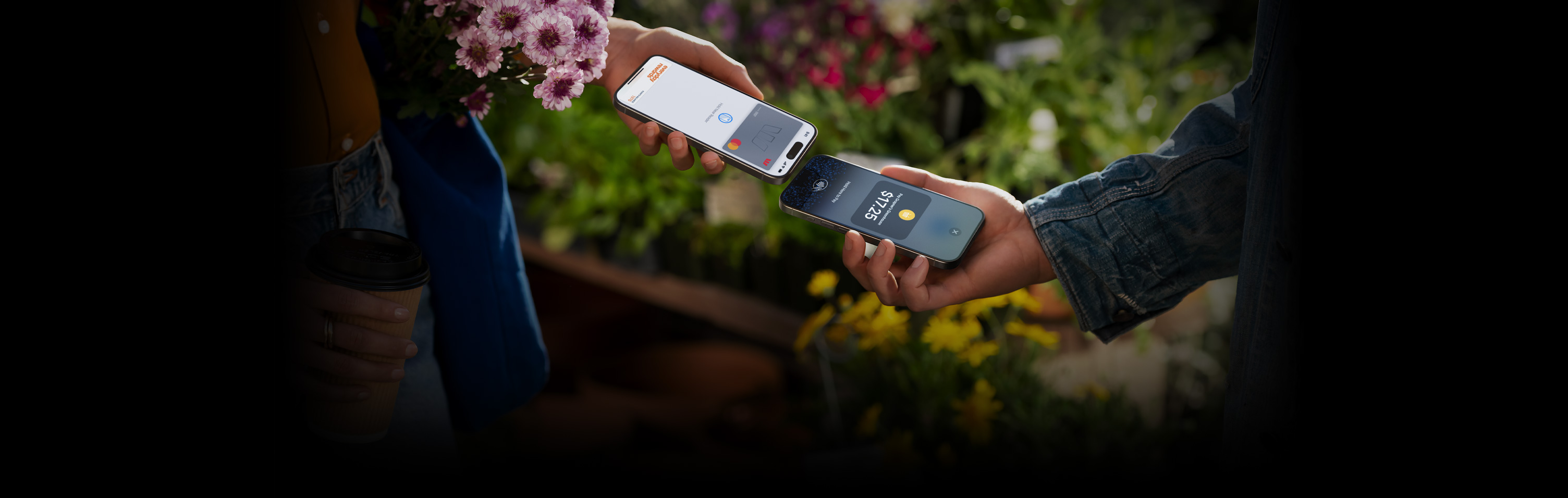 An image of two people holding their iPhone devices together completing a transaction.