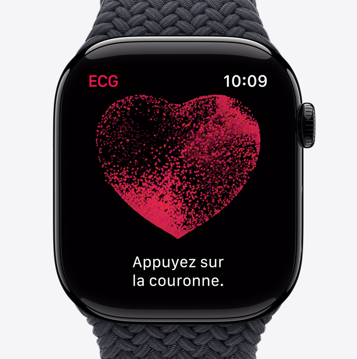 L’app ECG affichant un cœur rouge qui contient des particules en mouvement, ainsi que la phrase : “Appuyez sur la couronne.”