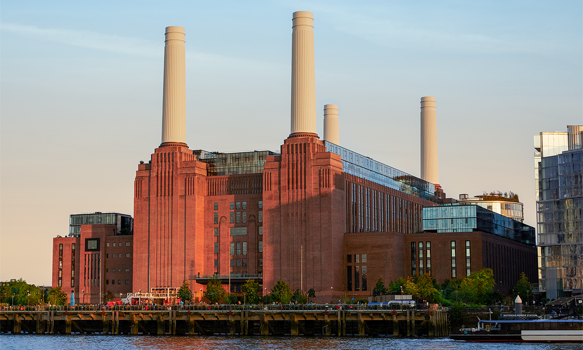 Exterior view of the brick-clad Battersea building with its four chimneys.