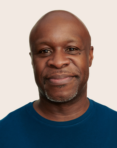 Apple Retail employee smiling and looking straight into the camera. 