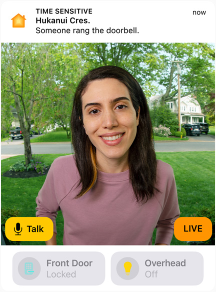 View of a doorbell camera shows a woman in a pink sweatshirt. The words “Talk” and “Live” are on screen.