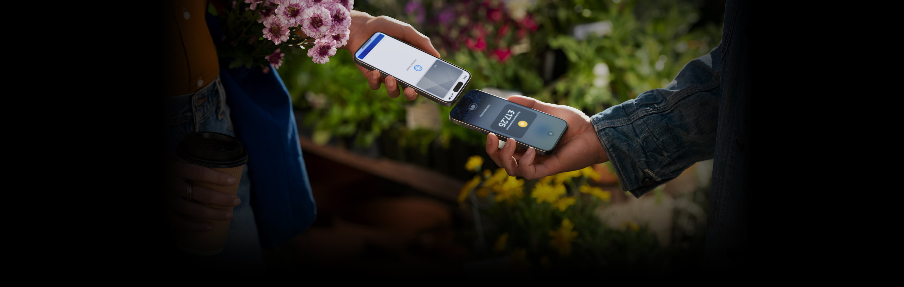 An image of two people holding their iPhone devices together completing a transaction.