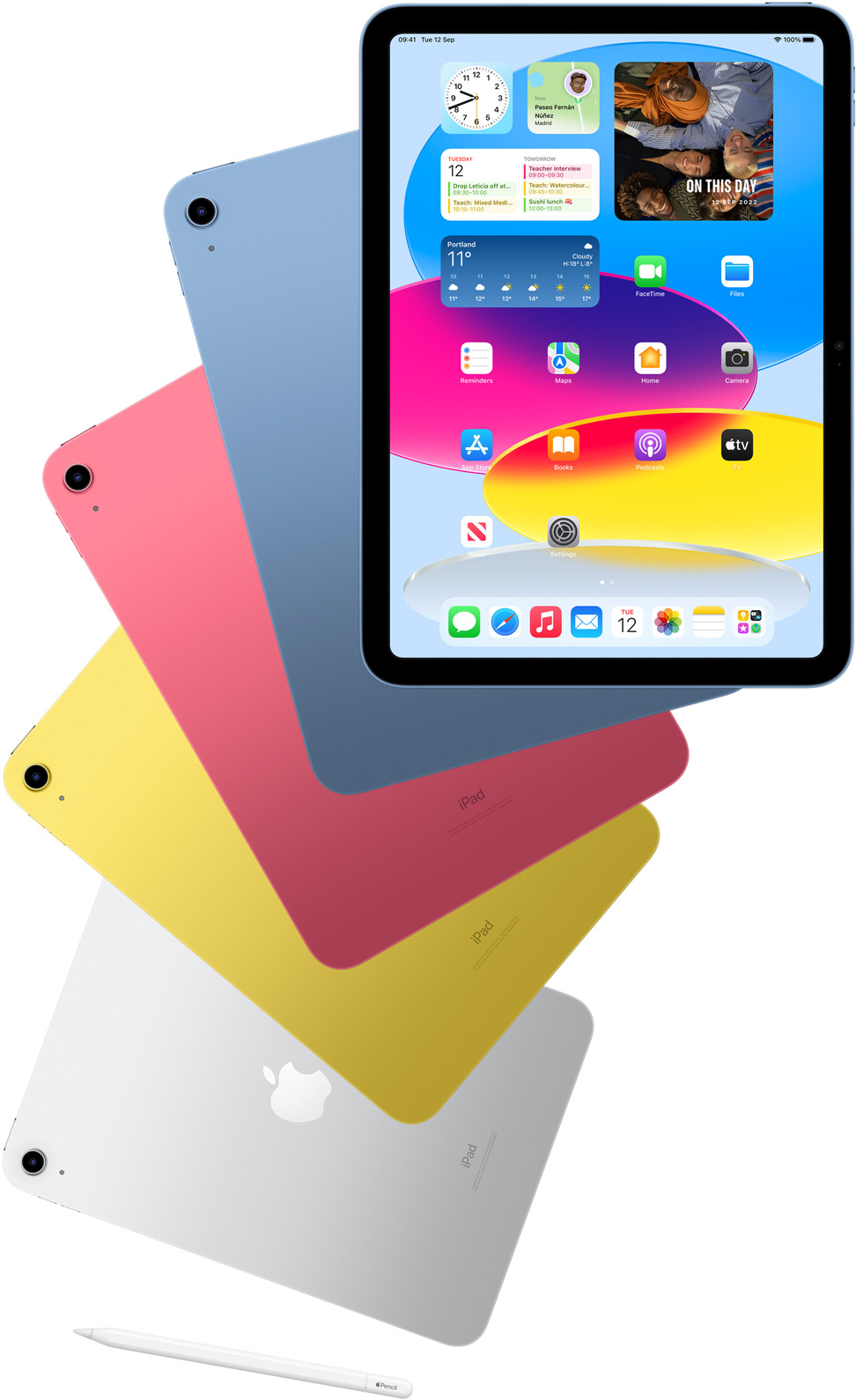 Front view iPad shows Home screen with blue, pink, yellow and silver rear-facing iPad devices behind it. An Apple Pencil sits near the arranged iPad models.