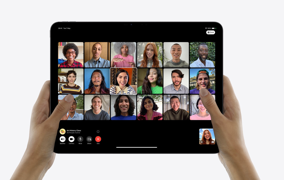 A pair of hands holding an iPad Pro showcasing a group FaceTime call