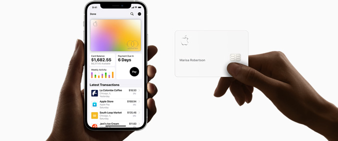 One hand holding an iPhone with financial information on screen and other hand holding an Apple Card