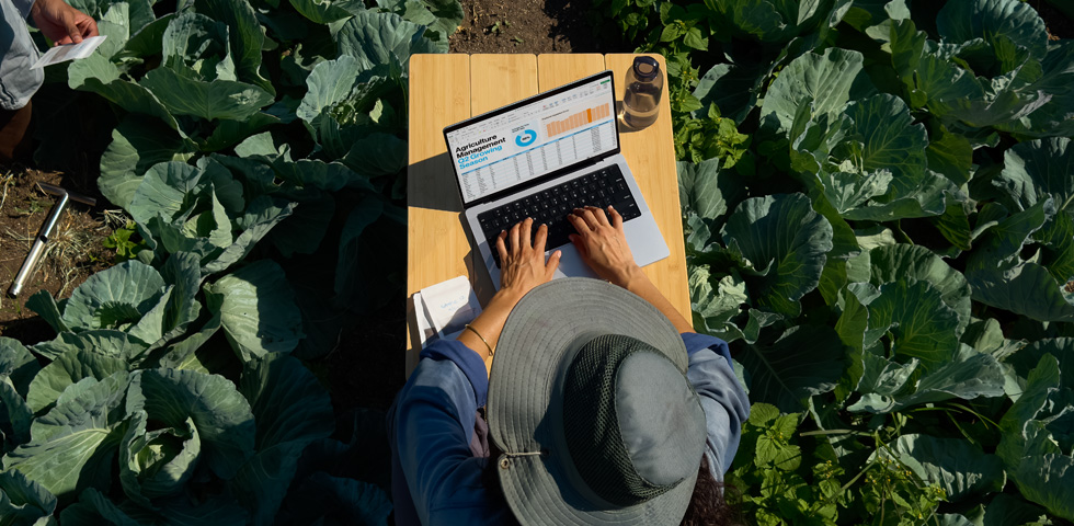 A person uses MacBook Pro with nano-texture display option outside, demonstrating the reduction in glare