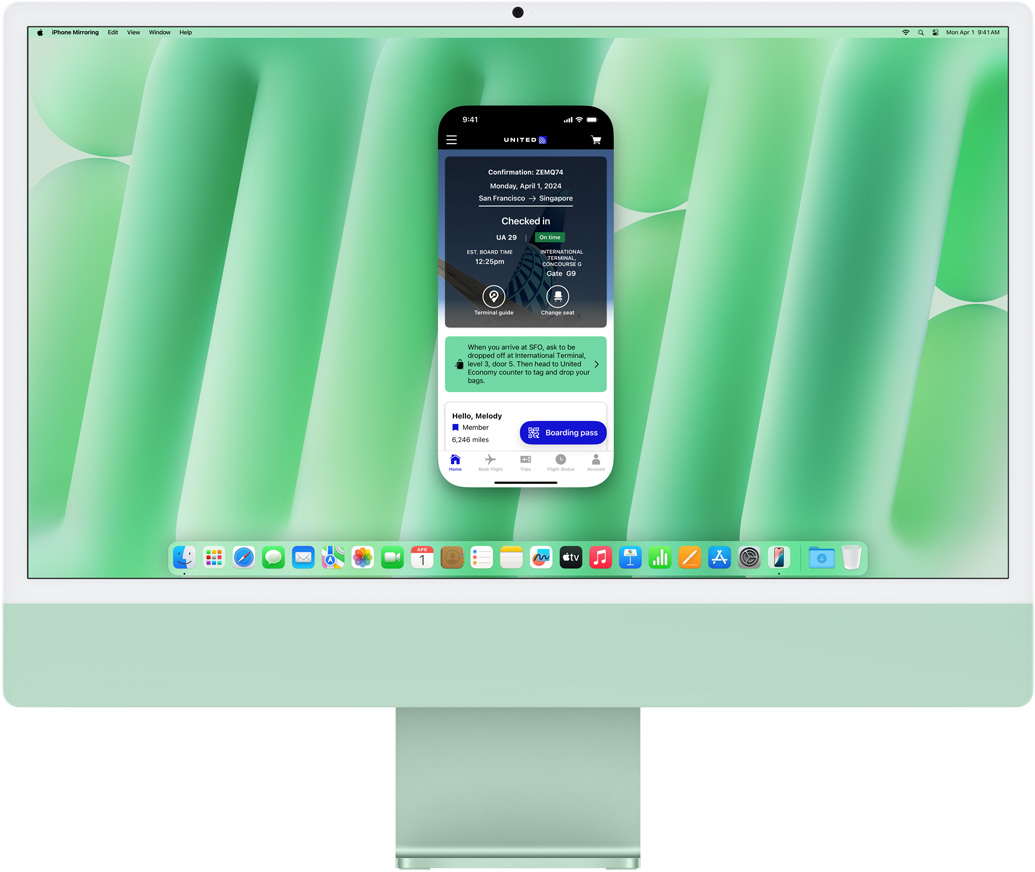 iPhone Mirroring feature demonstration. iPhone screen displaying Uber Eats app mirrored and controlled on iMac.